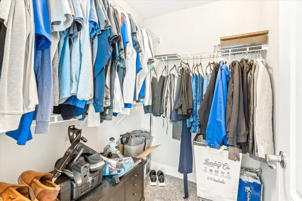 a bedroom with a large bed and a ceiling fan