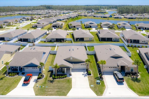 an aerial view of a house with garden space and street view