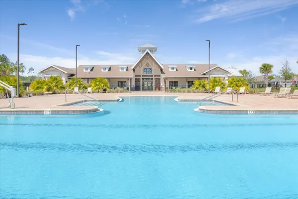 a view of a tennis ground with large trees