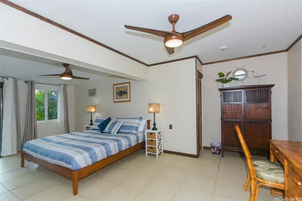 a bedroom with a bed and a desk