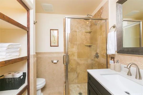 a bathroom with a sink a toilet and shower