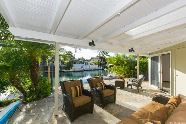 a balcony with furniture and garden view