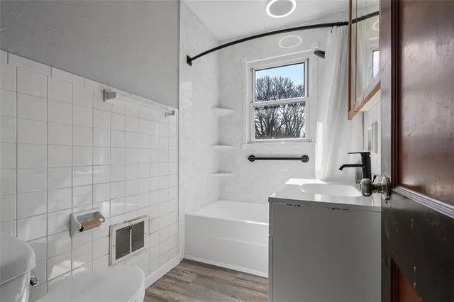 a bathroom with a bathtub and a sink