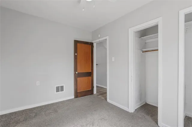 an empty room with closet area