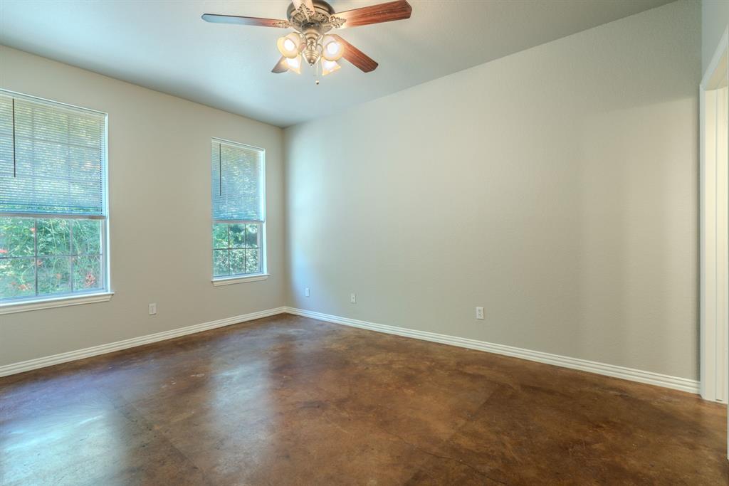 403 Summer Tree Lane Springtown, TX 76082 - Photo 7 of 19 Primary bedroom featuring a ceiling fan, fresh paint and stained concrete flooring