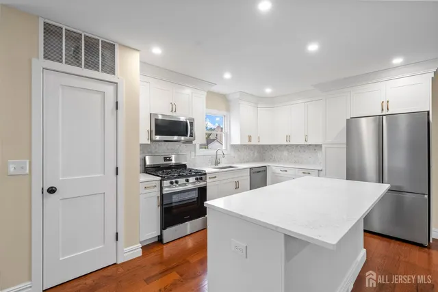 a view of kitchen with stainless steel appliances refrigerator oven and stove