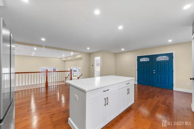 a bathroom with a granite countertop toilet and sink