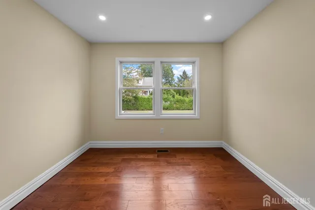 a view of a living room and kitchen with furniture wooden floor and windows