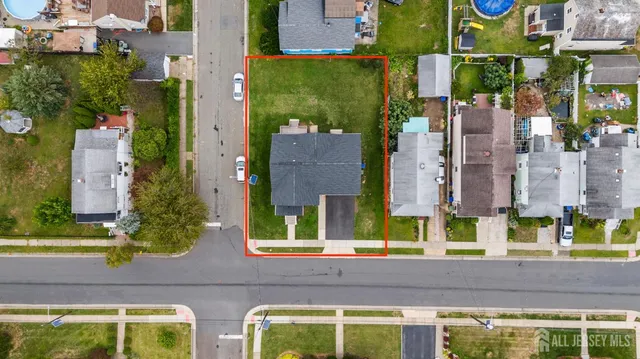 an aerial view of residential houses with yard and swimming pool