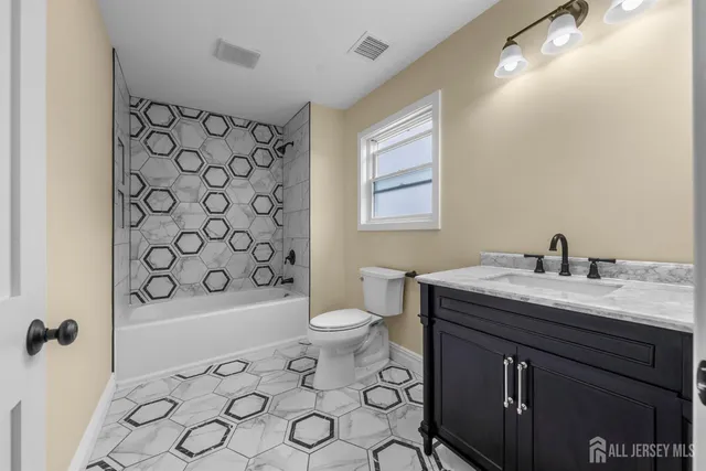 a view of an empty room with wooden floor and closet
