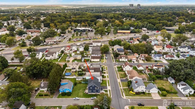 an aerial view of residential houses with city view
