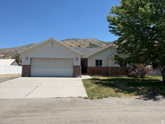 587 West 2400 South Perry, UT 84302 - Photo 1 of 46 Ranch-style residence featuring a two-car garage, brick veneer foundation, and siding exterior