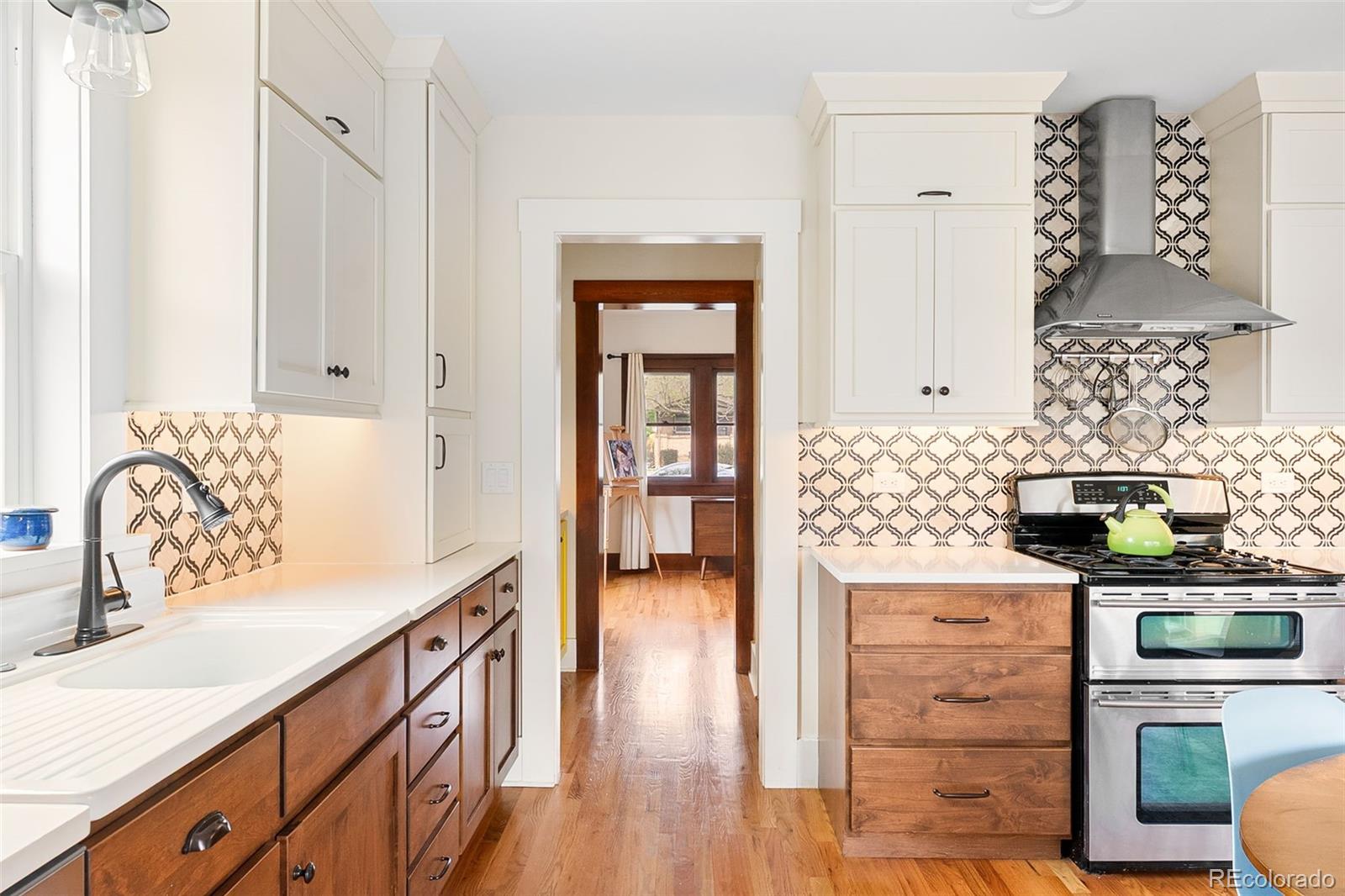 1959 South Washington Street Denver, CO 80210 - Photo 21 of 50 a kitchen with stainless steel appliances a stove a sink and a refrigerator