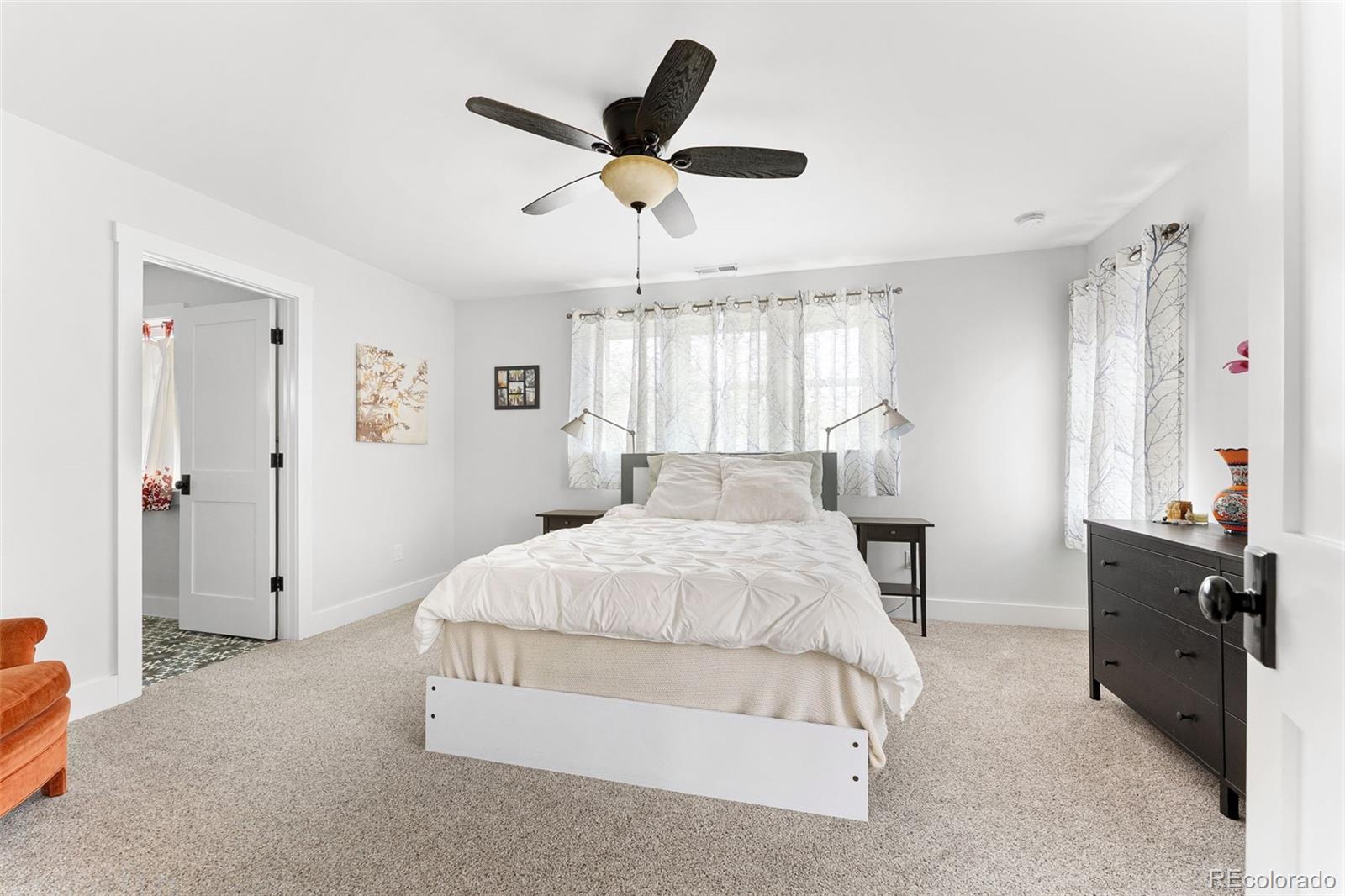 1959 South Washington Street Denver, CO 80210 - Photo 27 of 50 a spacious bedroom with a bed and a chandelier