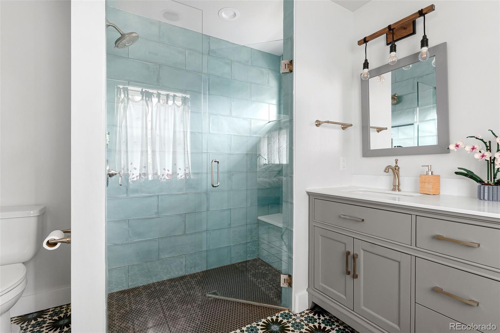 1959 South Washington Street Denver, CO 80210 - Photo 30 of 50 a bathroom with a shower sink and mirror
