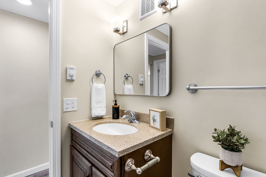 33 Maple Crest Circle, Unit D Holyoke, MA 01040 - Photo 14 of 28 a bathroom with a sink vanity and a mirror