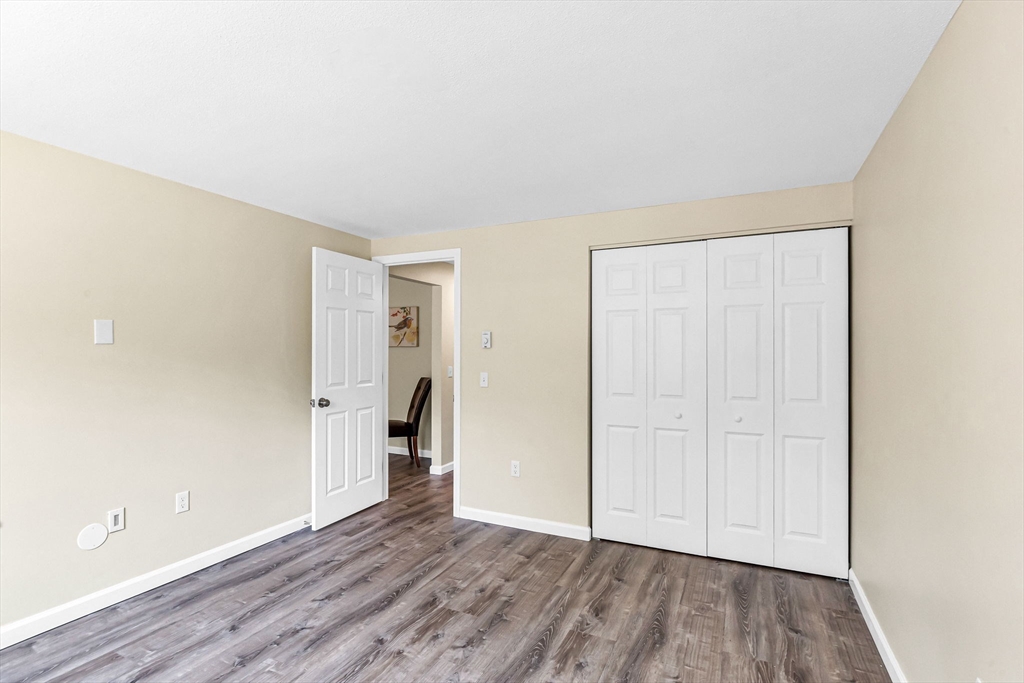 33 Maple Crest Circle, Unit D Holyoke, MA 01040 - Photo 17 of 28 an empty room with wooden floor and closet