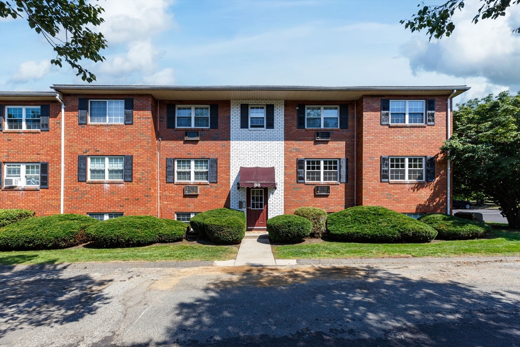 33 Maple Crest Circle, Unit D Holyoke, MA 01040 - Photo 25 of 28 a front view of a house with a yard and trees