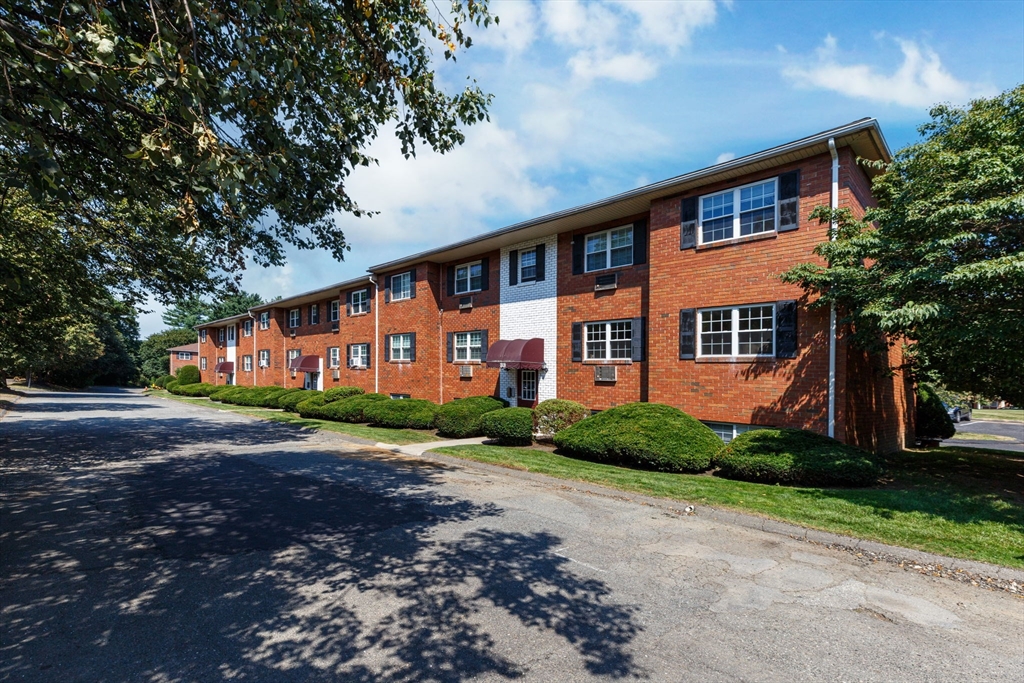 33 Maple Crest Circle, Unit D Holyoke, MA 01040 - Photo 26 of 28 a front view of a house with a yard