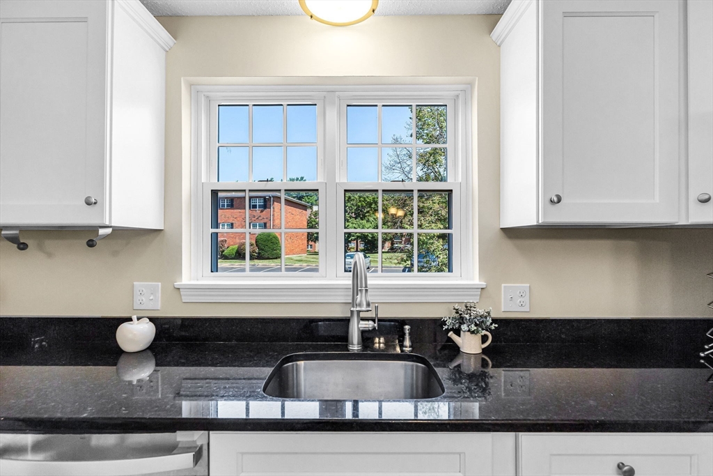33 Maple Crest Circle, Unit D Holyoke, MA 01040 - Photo 3 of 28 a kitchen with granite countertop a sink and a white cabinets