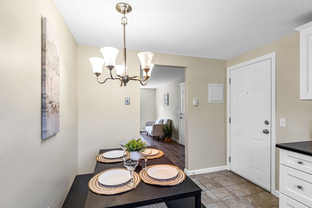 33 Maple Crest Circle, Unit D Holyoke, MA 01040 - Photo 4 of 28 a view of a dining room with furniture a chandelier and wooden floor