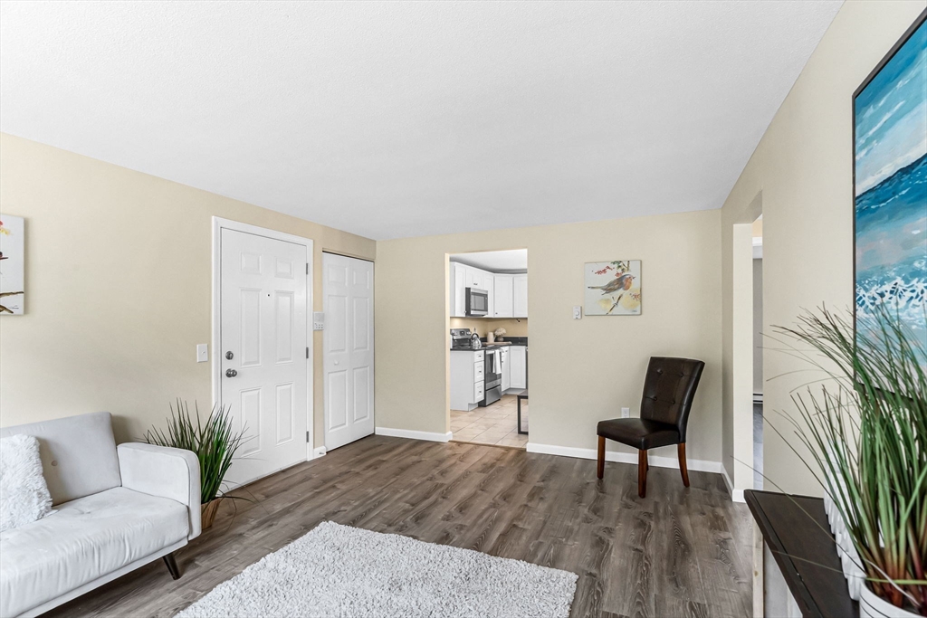 33 Maple Crest Circle, Unit D Holyoke, MA 01040 - Photo 7 of 28 a living room with furniture and a wooden floor