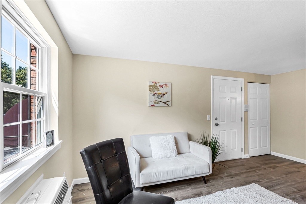 33 Maple Crest Circle, Unit D Holyoke, MA 01040 - Photo 8 of 28 a living room with furniture and a window