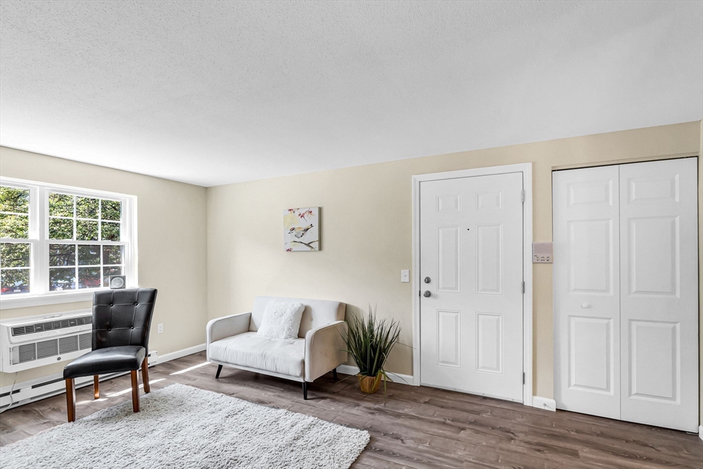 33 Maple Crest Circle, Unit D Holyoke, MA 01040 - Photo 9 of 28 a living room with furniture and wooden floor