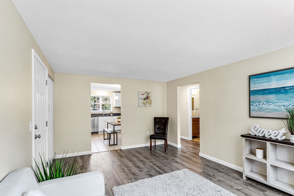 33 Maple Crest Circle, Unit D Holyoke, MA 01040 - Photo 10 of 28 a living room with furniture and a wooden floor