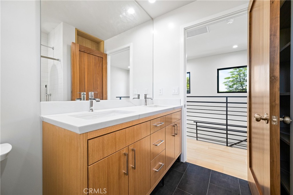 11431 De Celis Place Granada Hills, CA 91344 - Photo 11 of 20 a bathroom with a sink a mirror and a shower