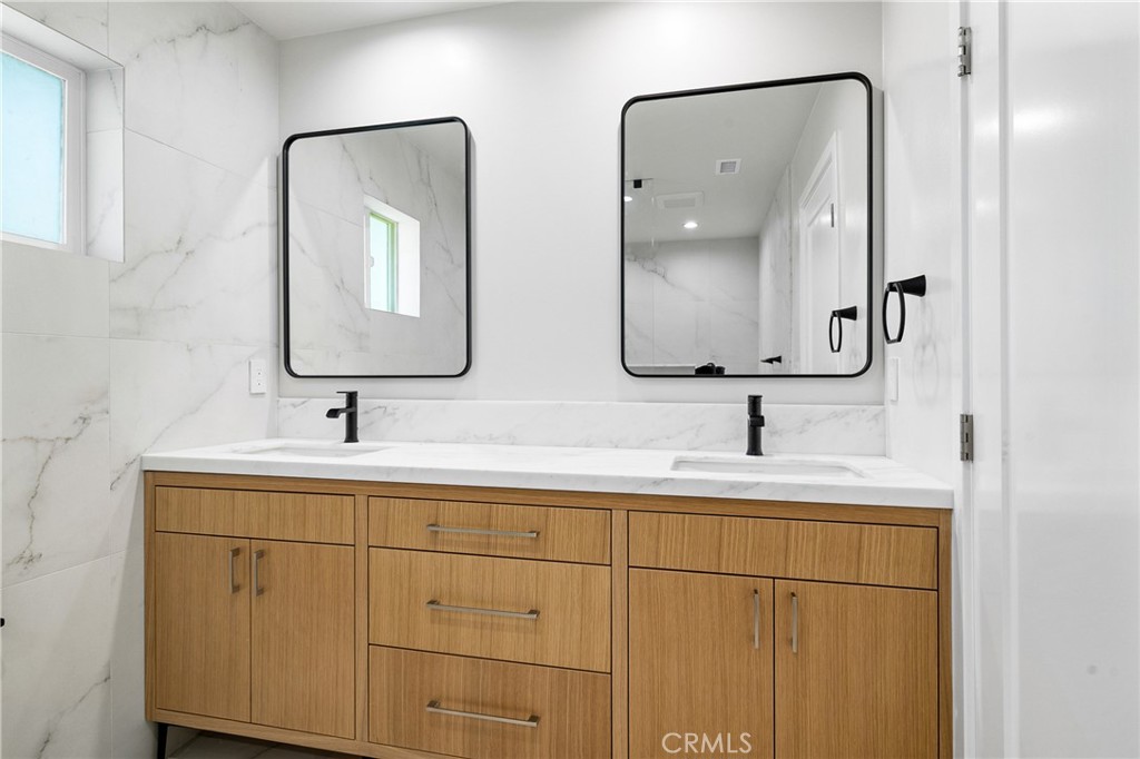 11431 De Celis Place Granada Hills, CA 91344 - Photo 13 of 20 a bathroom with 2 sink and a mirror