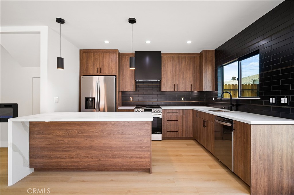 11431 De Celis Place Granada Hills, CA 91344 - Photo 10 of 20 a large kitchen with granite countertop a large counter top appliances and cabinets