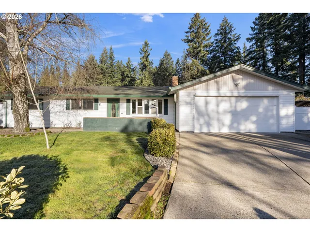 a view of a house with a yard and a garden