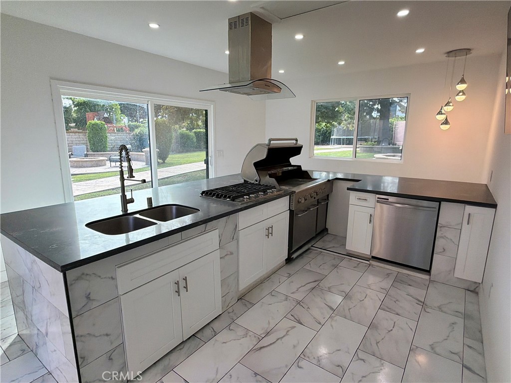 9455 Brandon Court Northridge, CA 91325 - Photo 14 of 15 a kitchen with stainless steel appliances granite countertop a sink stove and cabinets