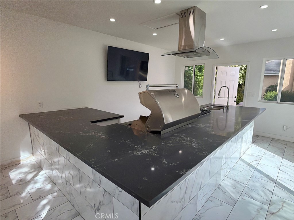 9455 Brandon Court Northridge, CA 91325 - Photo 15 of 15 a living room with stainless steel appliances furniture a rug and a view of kitchen