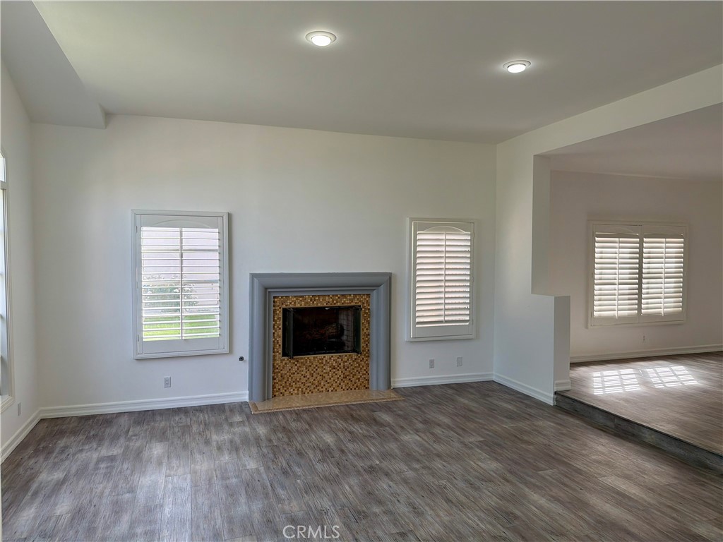 9455 Brandon Court Northridge, CA 91325 - Photo 2 of 15 an empty room with windows and fireplace