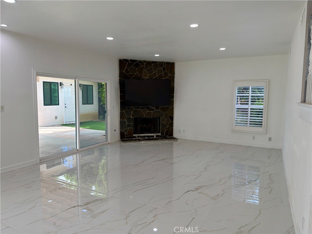 9455 Brandon Court Northridge, CA 91325 - Photo 3 of 15 a view of an empty room with a fireplace