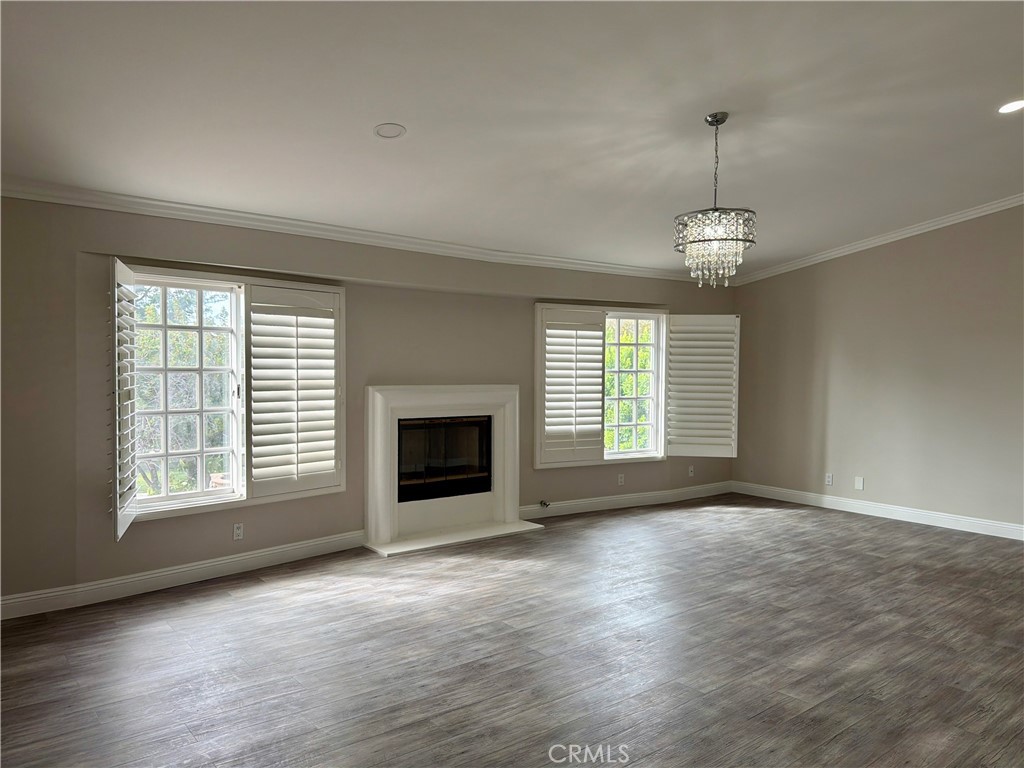 9455 Brandon Court Northridge, CA 91325 - Photo 4 of 15 an empty room with windows fireplace and sink