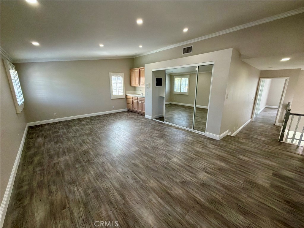 9455 Brandon Court Northridge, CA 91325 - Photo 8 of 15 an empty room with wooden floor and stairs