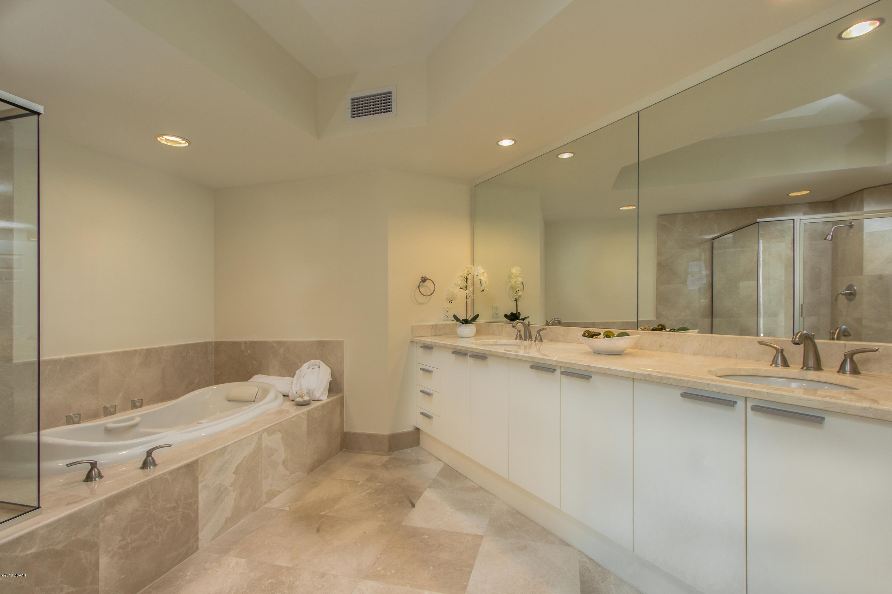 241 Riverside Drive, Unit 1409 Holly Hill, FL 32117 - Photo 18 of 35 a bathroom with a tub a sink and mirror