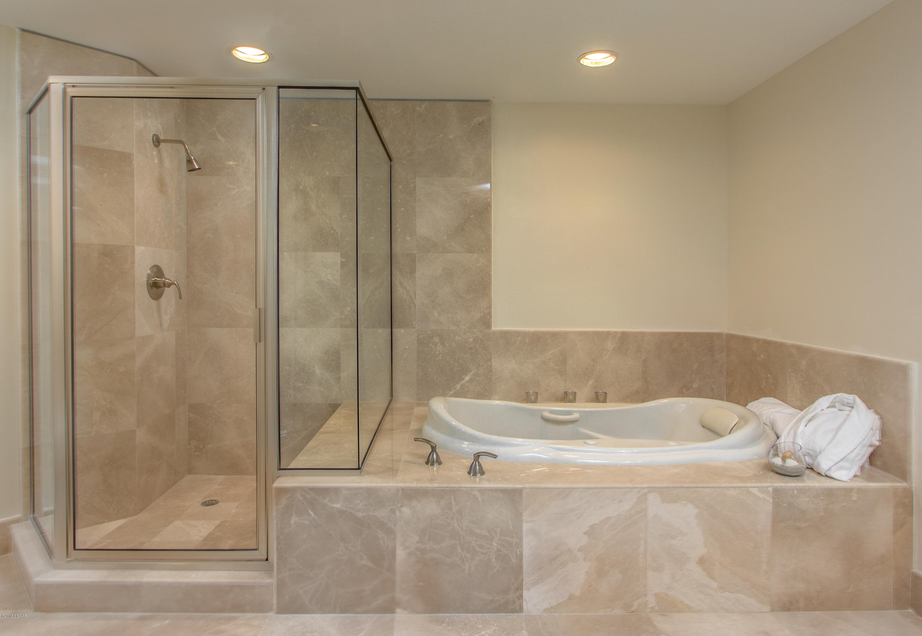 241 Riverside Drive, Unit 1409 Holly Hill, FL 32117 - Photo 19 of 35 a bathroom with a bathtub and a shower