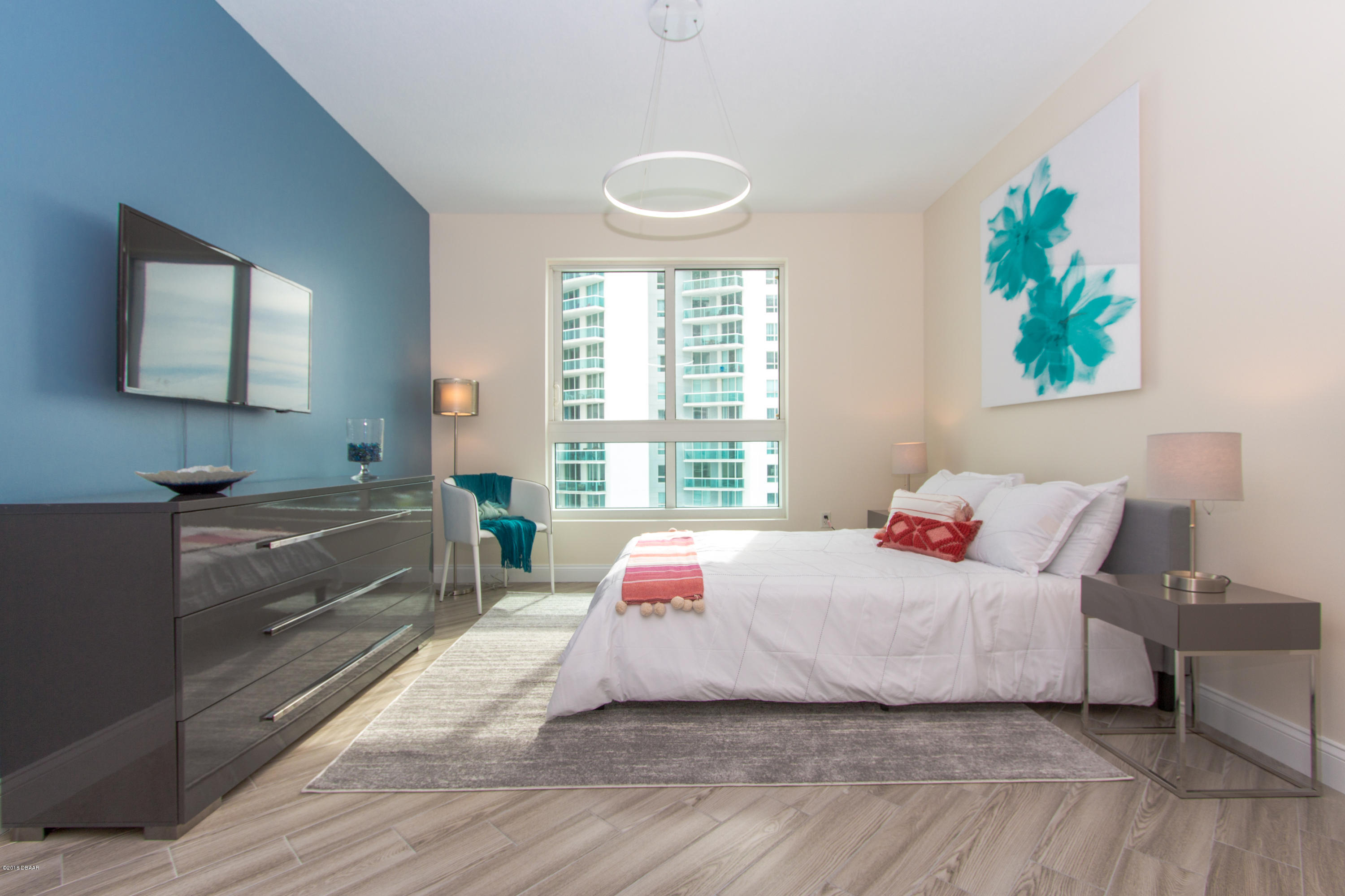 241 Riverside Drive, Unit 1409 Holly Hill, FL 32117 - Photo 20 of 35 a bedroom with a bed and a large window
