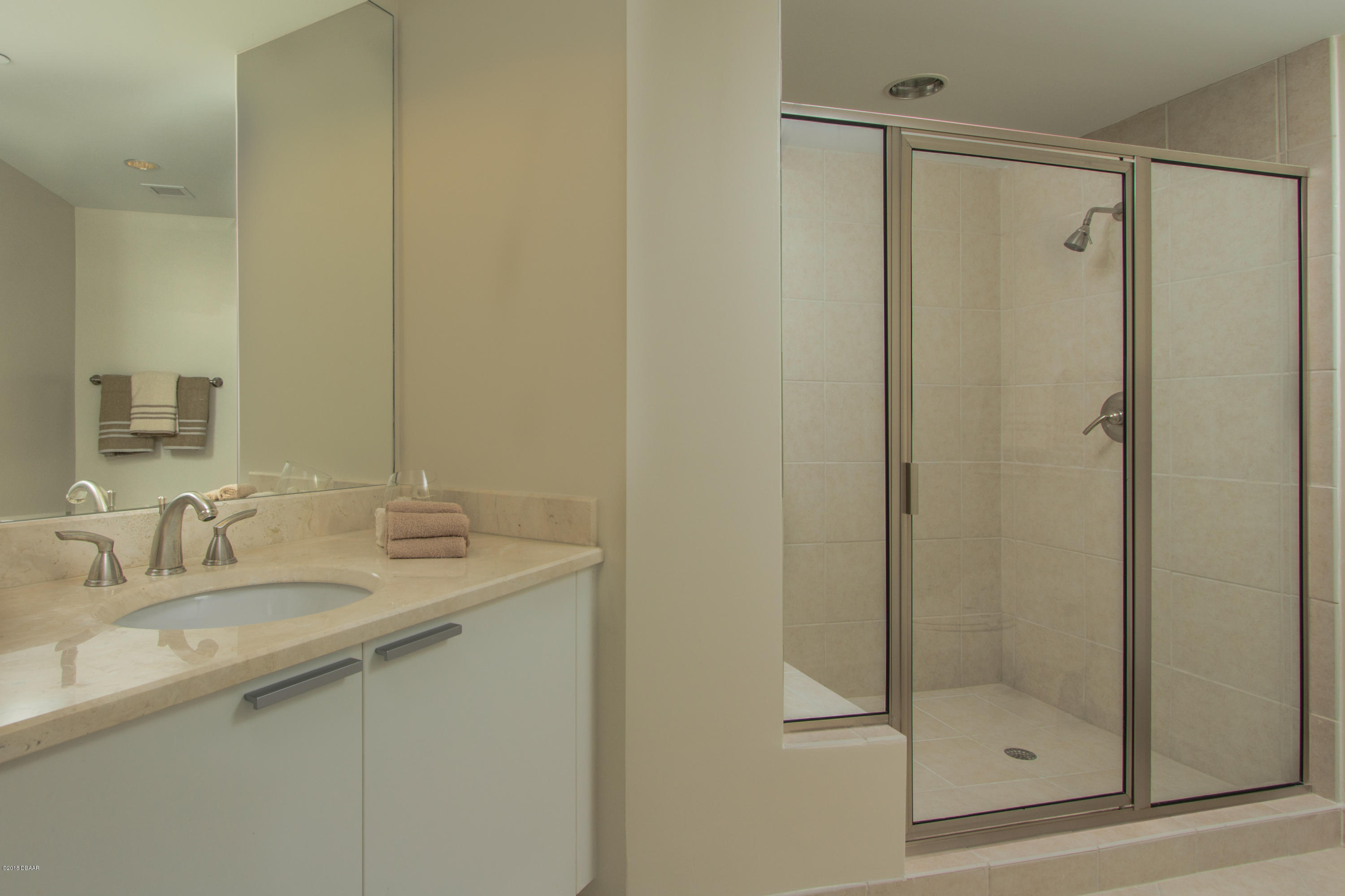241 Riverside Drive, Unit 1409 Holly Hill, FL 32117 - Photo 21 of 35 a bathroom with a shower and a sink