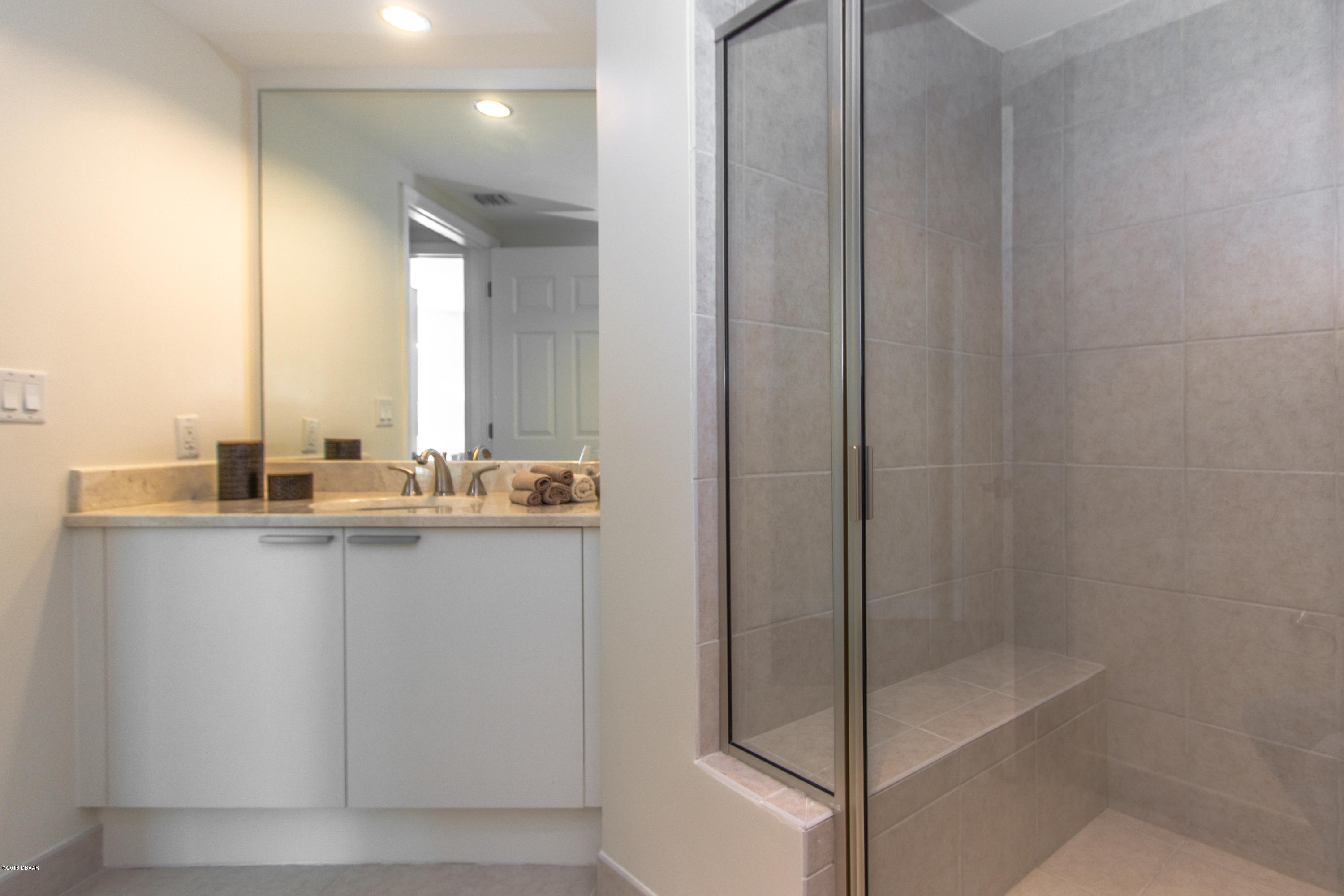 241 Riverside Drive, Unit 1409 Holly Hill, FL 32117 - Photo 22 of 35 a bathroom with a shower and a sink