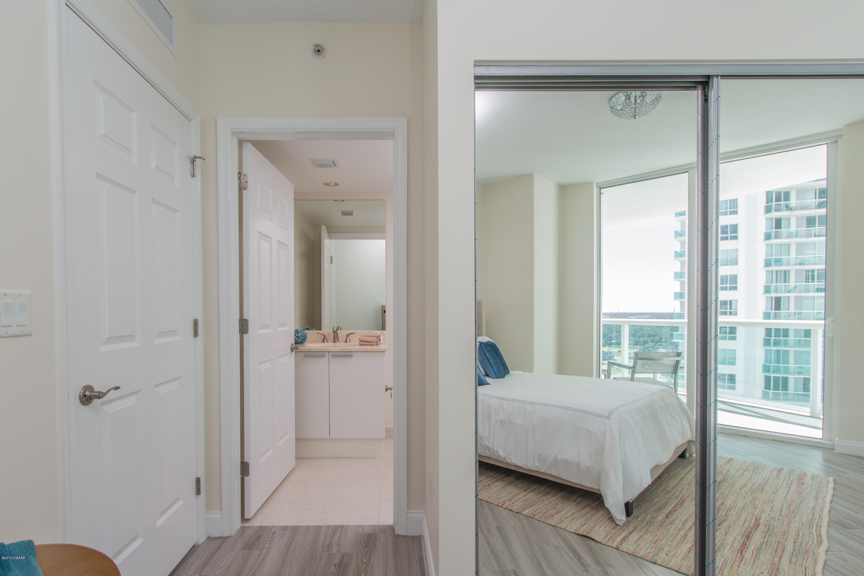 241 Riverside Drive, Unit 1409 Holly Hill, FL 32117 - Photo 26 of 35 a bedroom with a bed and a large window