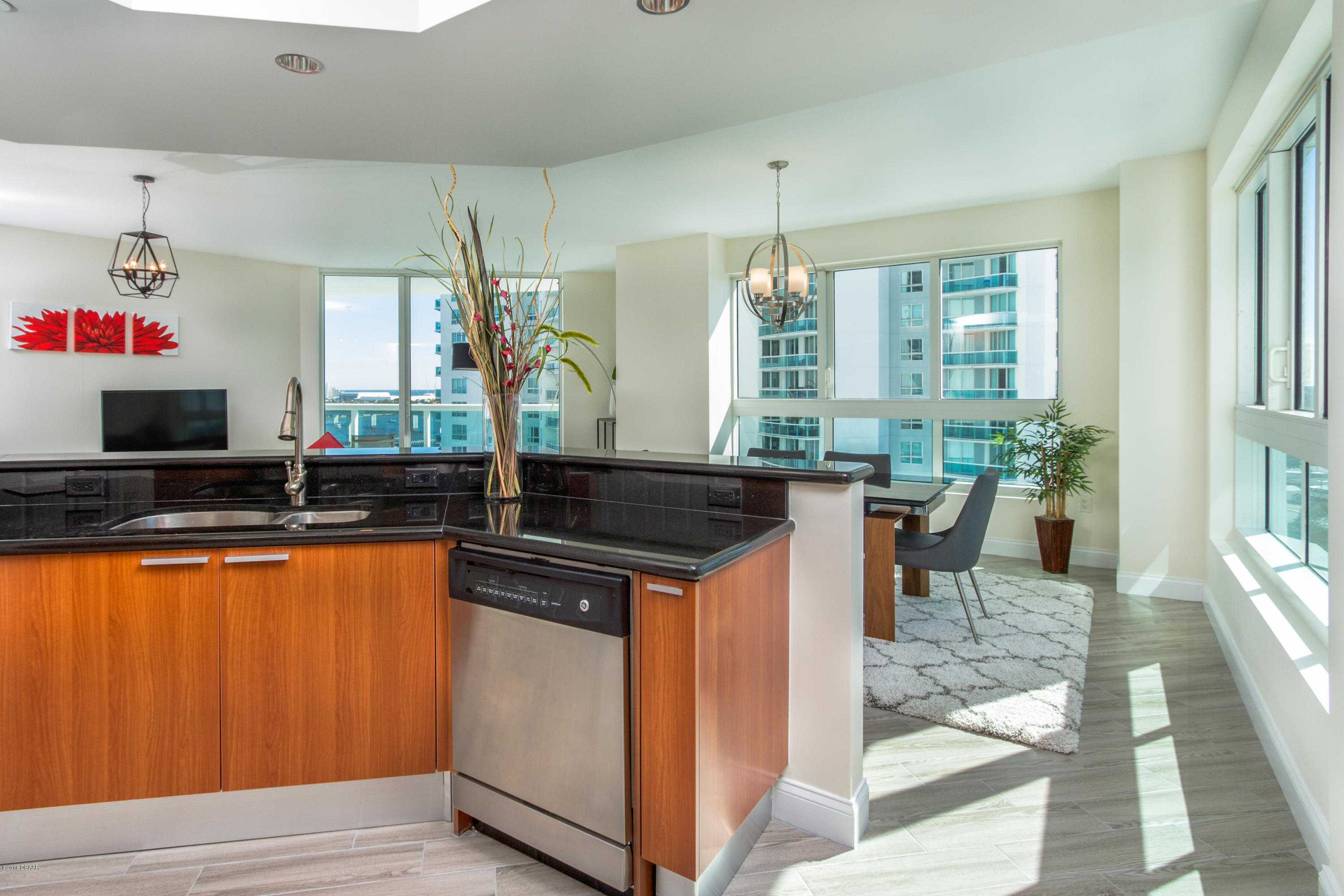 241 Riverside Drive, Unit 1409 Holly Hill, FL 32117 - Photo 10 of 35 a kitchen with stainless steel appliances granite countertop a sink and a stove
