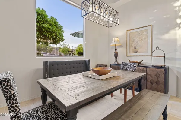 a view of a dining room with furniture and a chandelier