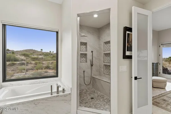 a dining room with furniture and a floor to ceiling window