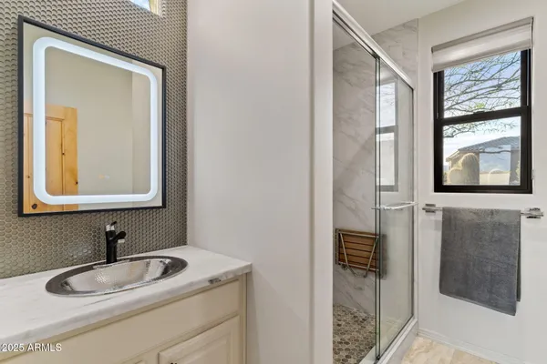 a living room with furniture potted plant and a large window