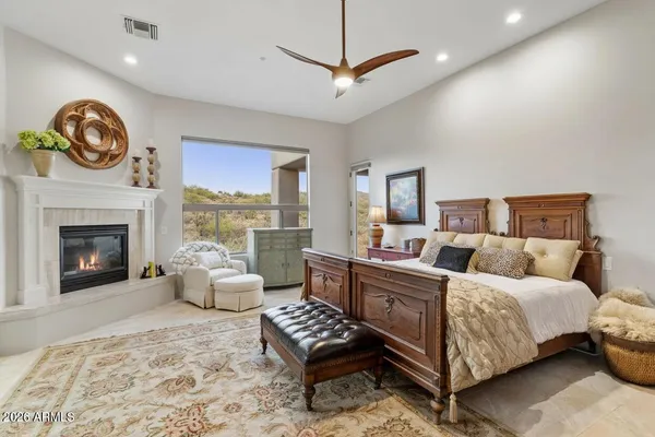 a bedroom with a bed and a fireplace